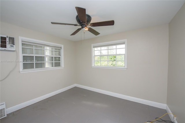 unfurnished room with ceiling fan and baseboards