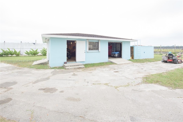 view of outbuilding with fence