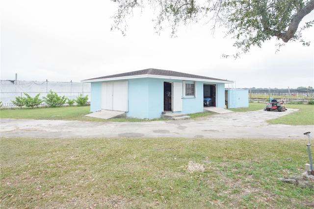 view of outbuilding featuring fence and an outdoor structure