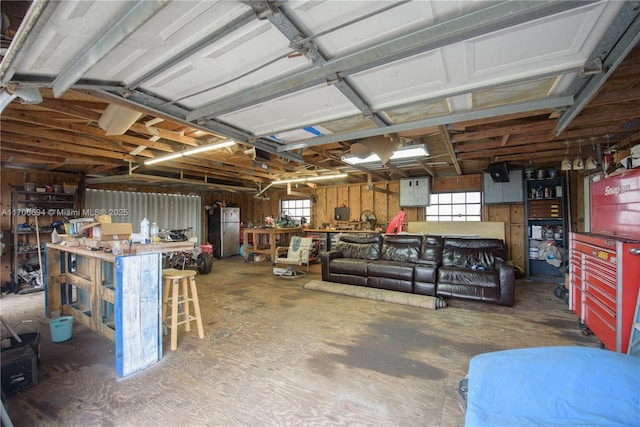 garage with freestanding refrigerator and a workshop area