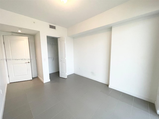 unfurnished bedroom featuring tile patterned floors and a closet