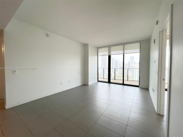 tiled spare room with expansive windows