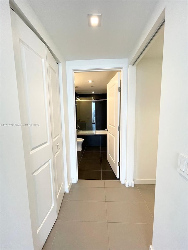 hallway featuring tile patterned flooring