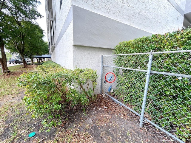 view of home's exterior with fence and stucco siding