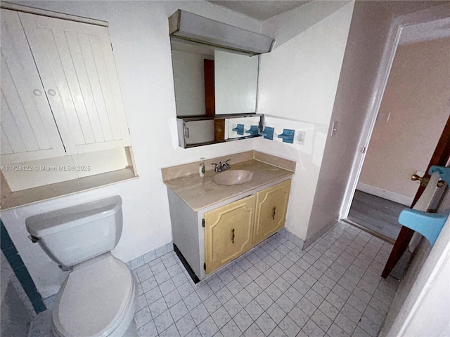 bathroom with toilet and vanity