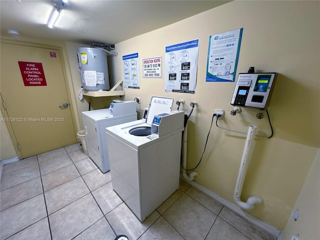 washroom with electric water heater, light tile patterned floors, and washer hookup