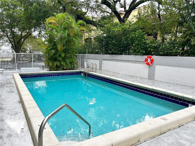 view of swimming pool featuring fence and a fenced in pool