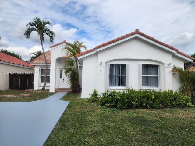 mediterranean / spanish-style house featuring a front lawn