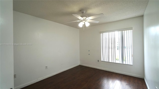 spare room with ceiling fan, dark wood-type flooring, and a textured ceiling