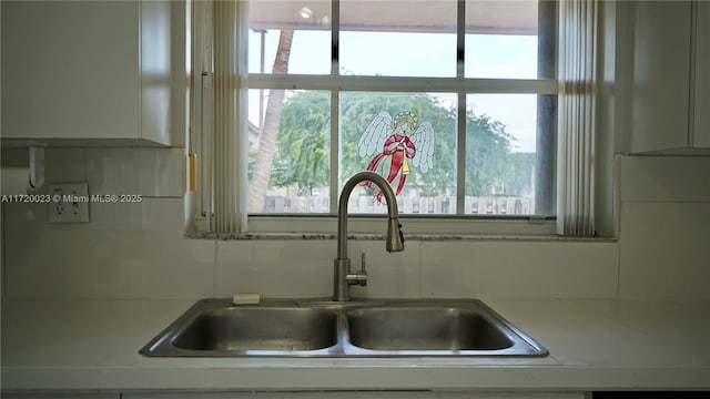 details featuring sink and backsplash