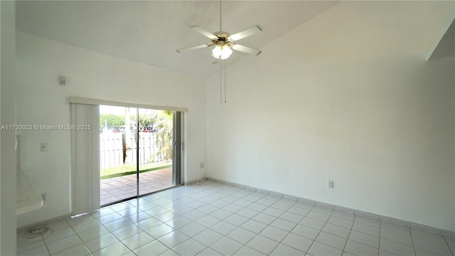 empty room with ceiling fan, light tile patterned floors, and high vaulted ceiling