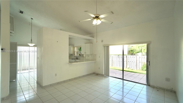unfurnished room featuring ceiling fan, light tile patterned floors, lofted ceiling, and sink