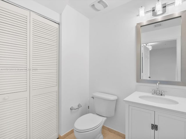 bathroom with toilet and vanity