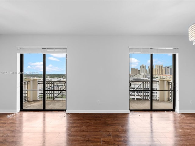 unfurnished room with hardwood / wood-style flooring