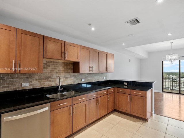 kitchen with light tile patterned flooring, stainless steel dishwasher, hanging light fixtures, and sink