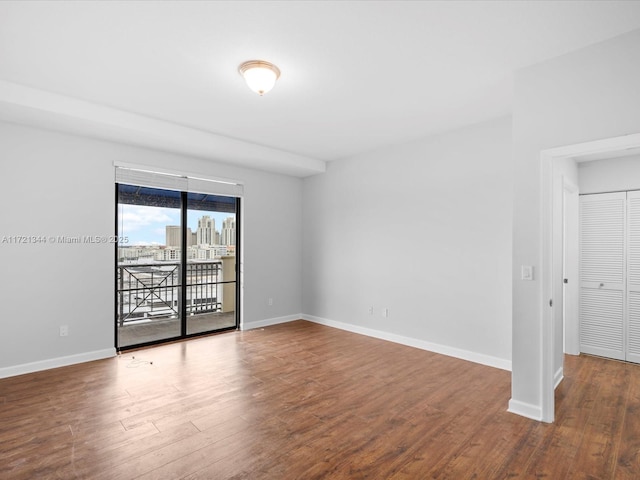 empty room with hardwood / wood-style flooring