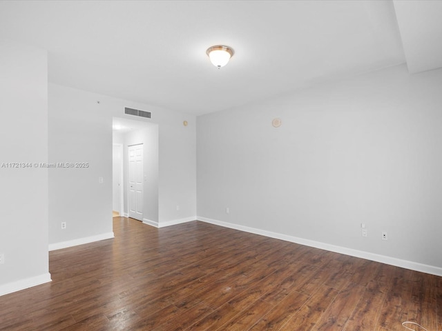 unfurnished room featuring dark wood-type flooring