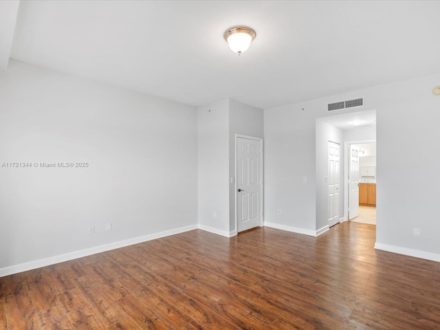 unfurnished room featuring dark hardwood / wood-style flooring