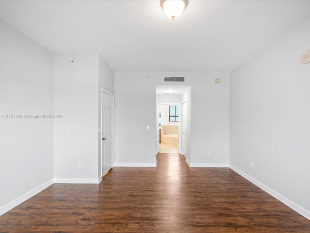 empty room featuring dark hardwood / wood-style flooring