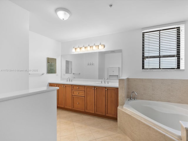 bathroom with tiled bath, tile patterned flooring, and vanity