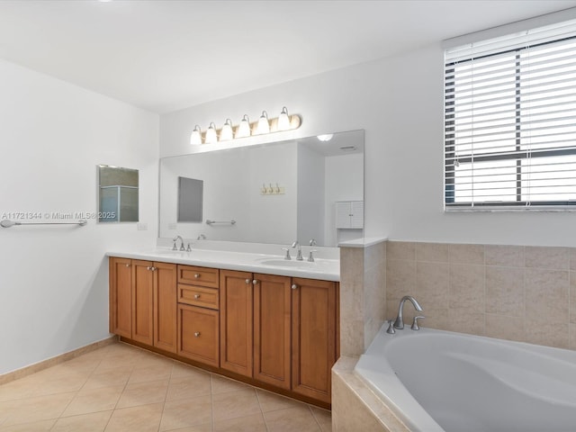 bathroom featuring tiled bath, tile patterned floors, and vanity