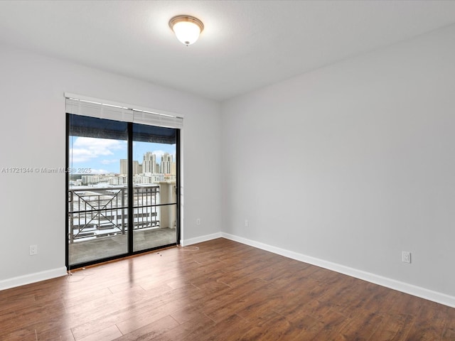 empty room with hardwood / wood-style floors