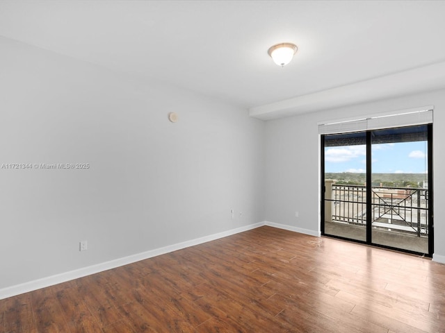 spare room with wood-type flooring