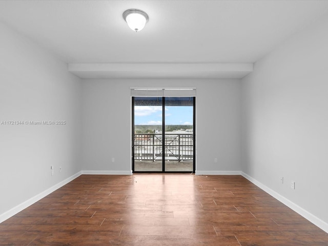 spare room featuring dark hardwood / wood-style flooring