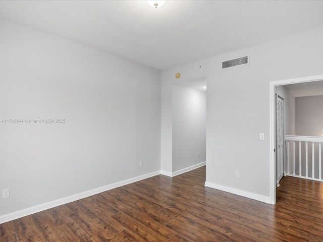 empty room featuring dark wood-type flooring