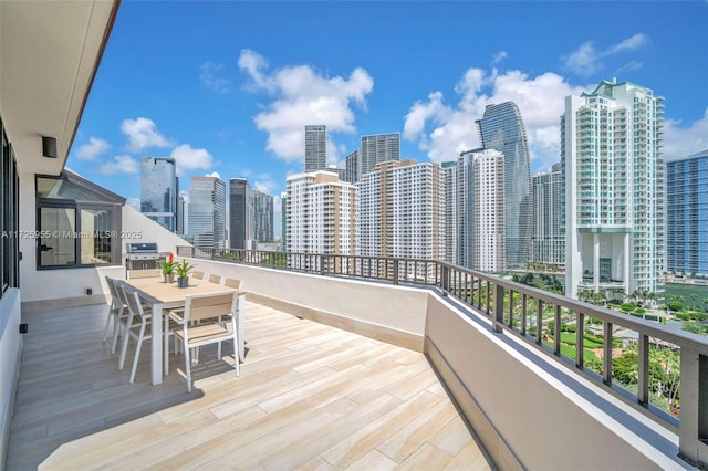 wooden deck featuring a grill