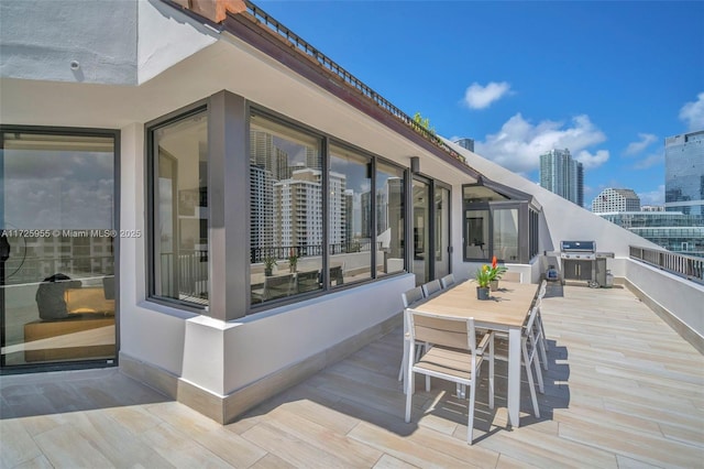 wooden deck featuring a grill