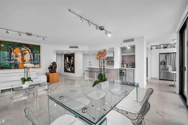 dining room with wine cooler and bar area