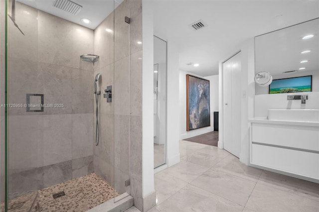 bathroom featuring vanity and a tile shower