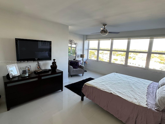 tiled bedroom featuring ceiling fan