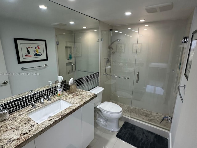 bathroom with toilet, a shower with shower door, decorative backsplash, tile patterned flooring, and vanity