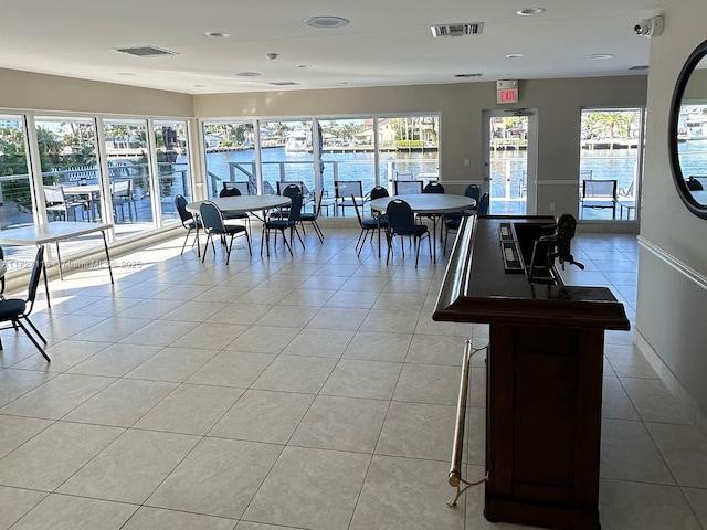 3300 NE 36th St Unit 605, Fort Lauderdale, FL 33308 - dining room with light tile patterned floors, a water view, recessed lighting, and baseboards