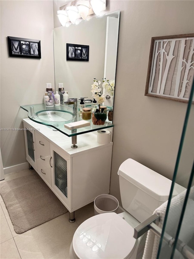 bathroom with vanity, tile patterned floors, and toilet