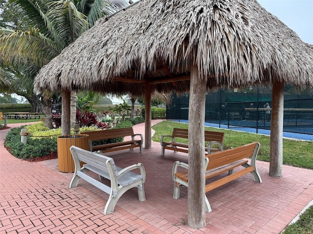 view of property's community with a gazebo and tennis court