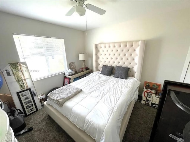 bedroom with ceiling fan and dark carpet