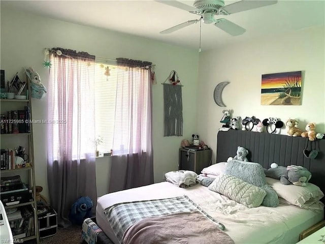 bedroom featuring ceiling fan, carpet flooring, and multiple windows