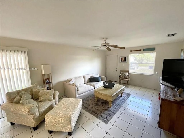 tiled living room featuring ceiling fan