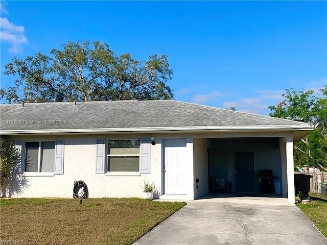 ranch-style house with a front lawn and a carport