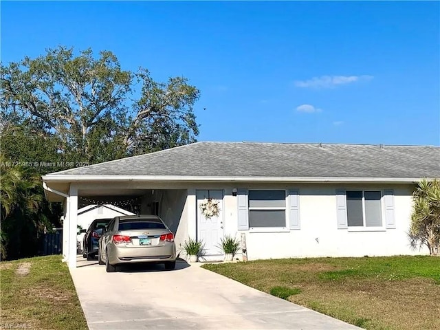 view of front of home with a front lawn and a carport