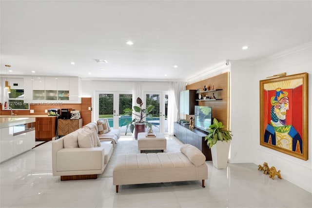 living room with light tile patterned floors, crown molding, and french doors