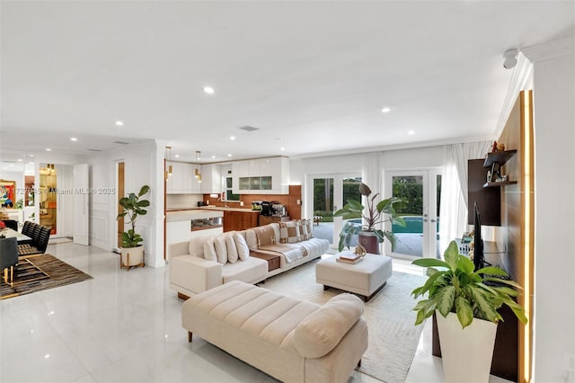 living room with french doors and crown molding