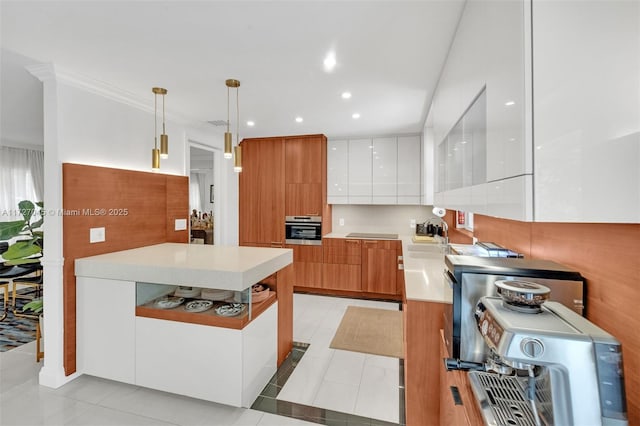 kitchen featuring oven, a kitchen island, light tile patterned flooring, white cabinetry, and hanging light fixtures