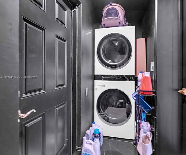 laundry area featuring stacked washer / drying machine