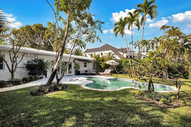 view of pool featuring a lawn and a patio