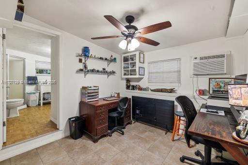 office area with ceiling fan and a wall unit AC