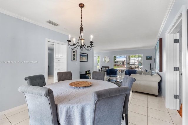 tiled dining area featuring an inviting chandelier and ornamental molding